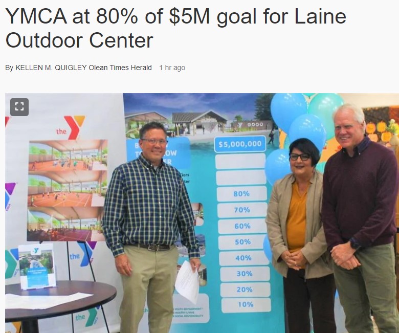 three board members standing next to a campaign thermometer that shows 80%